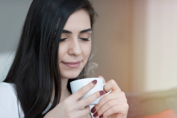 istock Beautiful young women drinking hot coffe 1130495116