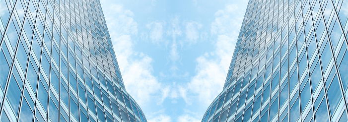 underside panoramic and perspective view to steel blue glass high rise building skyscrapers, business concept of successful industrial architecture