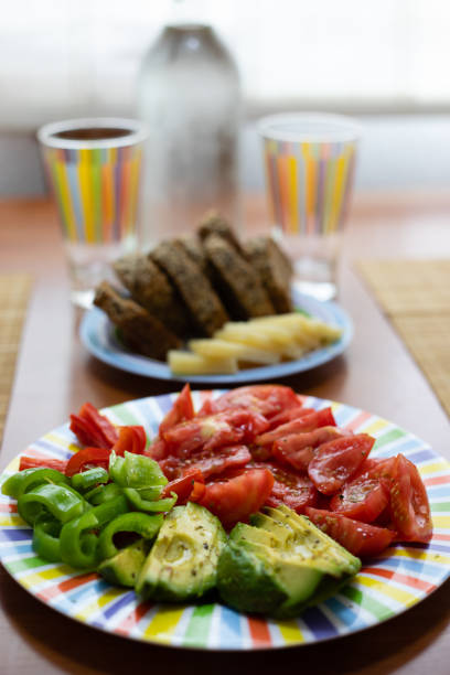 istock Dinner table with salad dish, bread and colorful water glass 1130500318