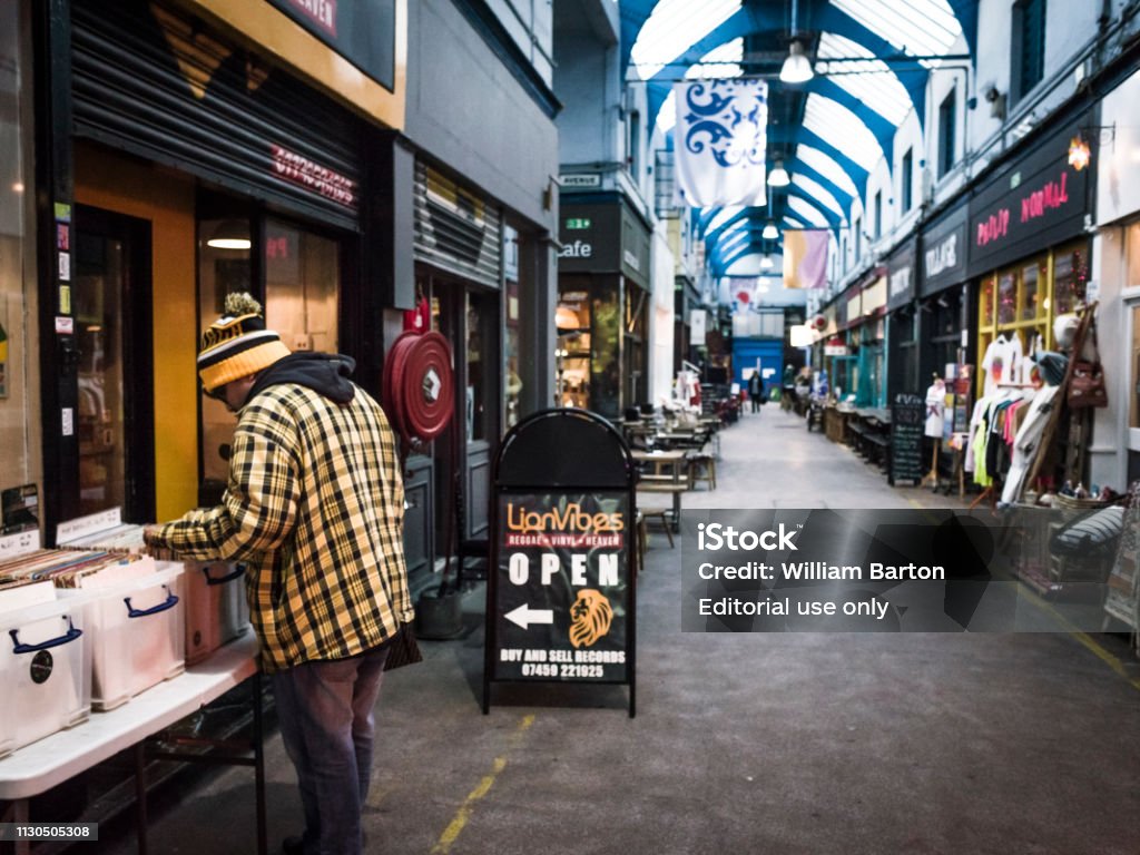 Brixton Market interior Brixton, UK- February, 2019: A man looking through vinyl records in Brixton Market, a vibrant and fashionable food and goods market in south west London Brixton Market Stock Photo