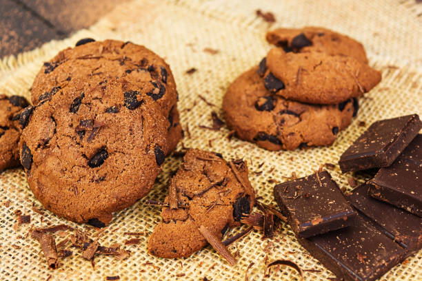 istock Cookies with chocolate on dark wooden background 1130506008