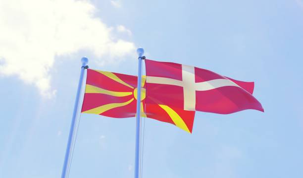 istock Macedonia and Denmark, two flags waving against blue sky 1130506076