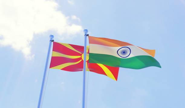 istock Macedonia and India, two flags waving against blue sky 1130506149