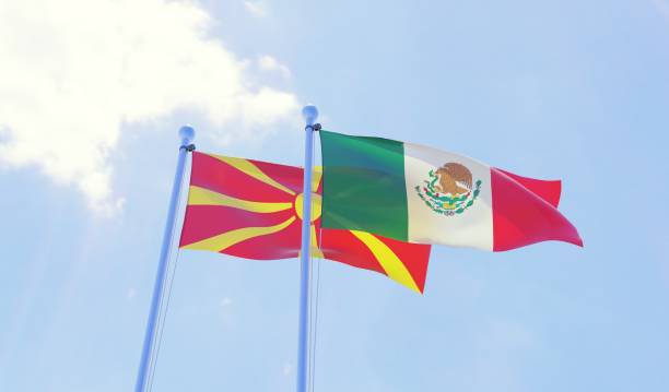 istock Macedonia and Mexico, two flags waving against blue sky 1130506202