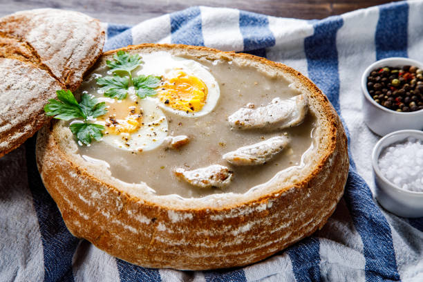 istock Sour rye soup in bread on wooden table 1130506725