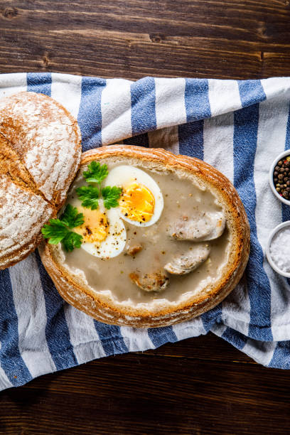 istock Sour rye soup in bread on wooden table 1130507327