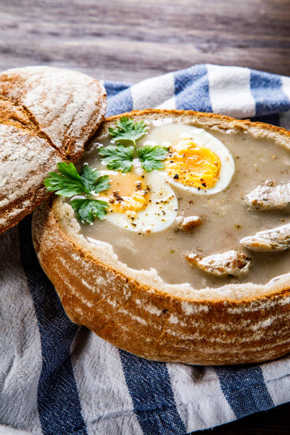 istock Sour rye soup in bread on wooden table 1130507471
