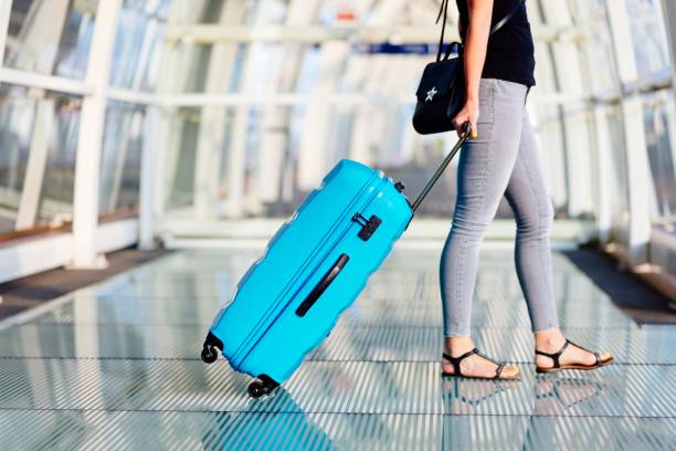 istock Woman with blue baggage suitcase 1130507553
