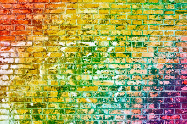 istock Colorful old brick wall background with rainbow effect 1130510264