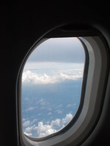 commercial airplane window view in mid air - cloud mid air cloudscape aerial view imagens e fotografias de stock