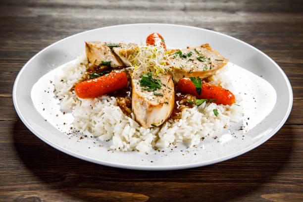 istock White rice with meat and vegetables on wooden background 1130511468
