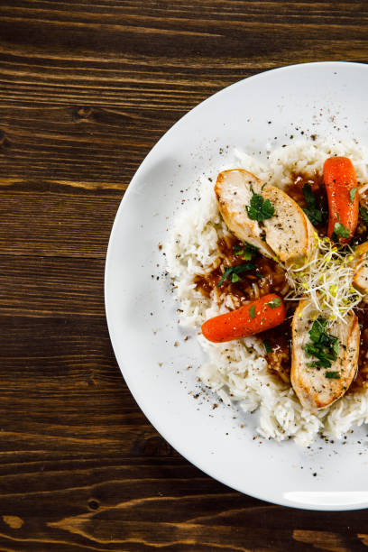 istock White rice with meat and vegetables on wooden background 1130511500