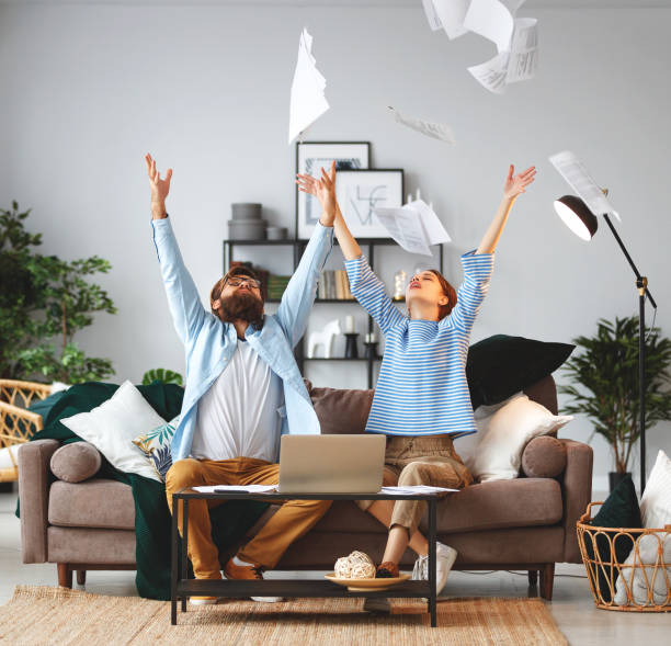 istock married couple with bills receipts documents and laptop at home 1130511619