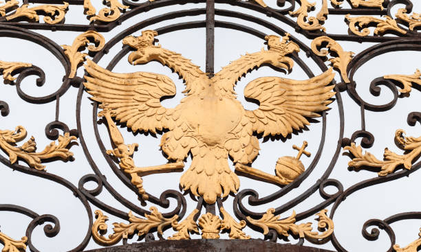 istock Golden Double Eagle in forged fence 1130512335