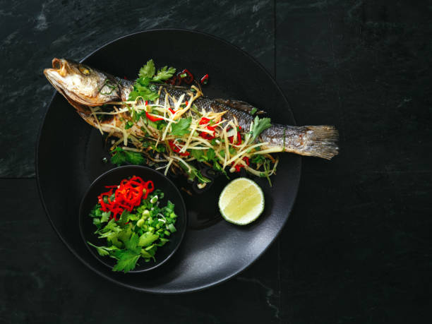 branzino al vapore - prepared fish prepared snapper freshness roasted foto e immagini stock