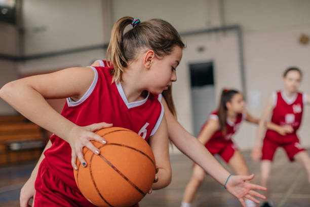istock Young girls playing basketball match 1130513200