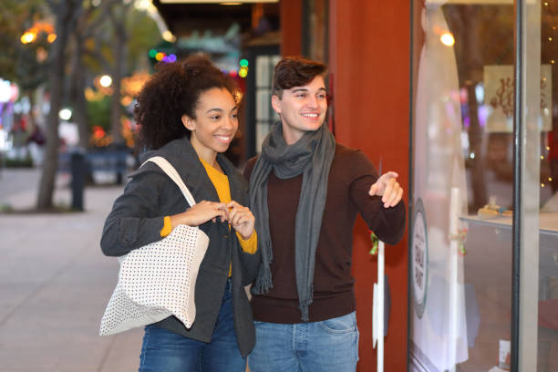 istock Holiday Fun Couple Shopping He Points 1130513310