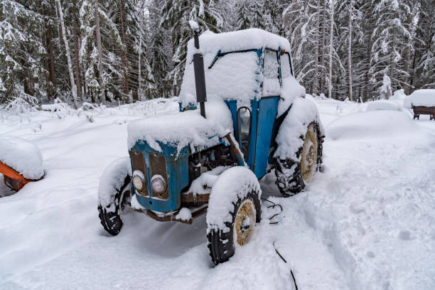 istock old blue tractor standing covered in snow 1130514765