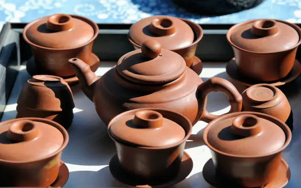 Brown clay teapot and tea cups for traditional Chinese tea ceremony