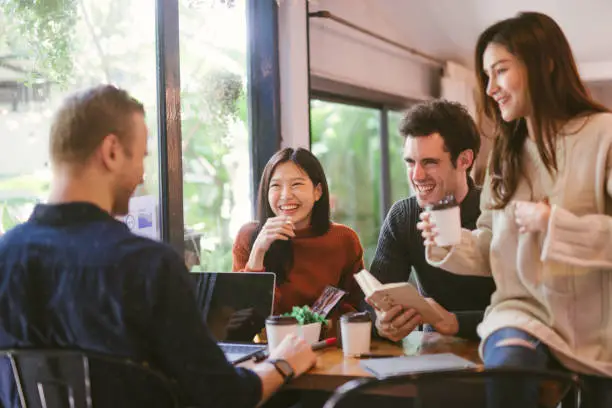 Photo of people talking happy in cafe