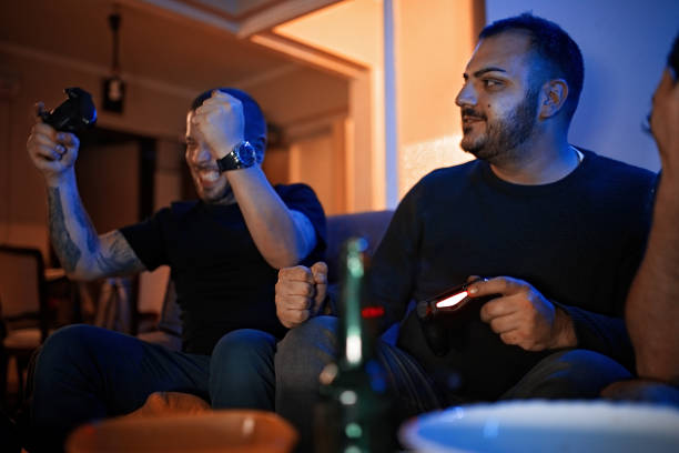 istock Two friends playing video games 1130520190