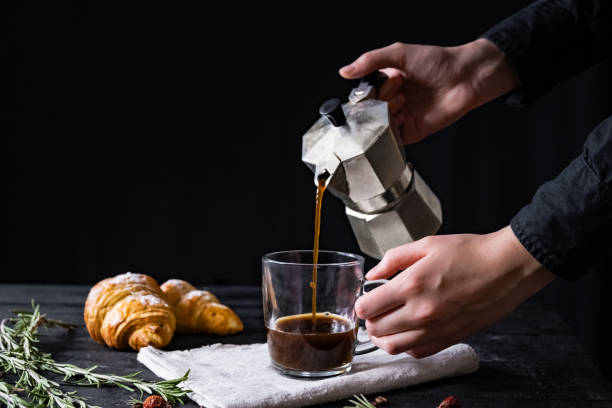 istock Pouring coffee from an italian percolator, shot in low key 1130521745