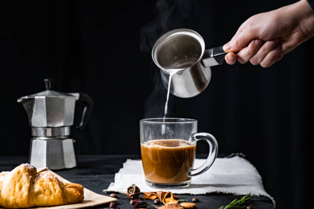 istock Pouring steaming milk into a cup of coffee 1130521977