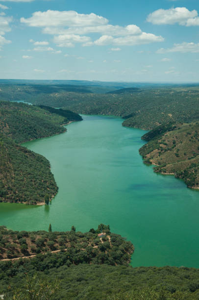 istock Tagus River running through a hilly valley with trees and house 1130523077