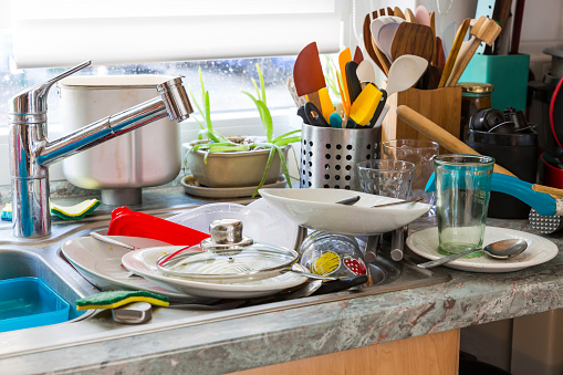 Compulsivo Syndrom Hoarding-cocina desordenada con pila de platos sucios photo