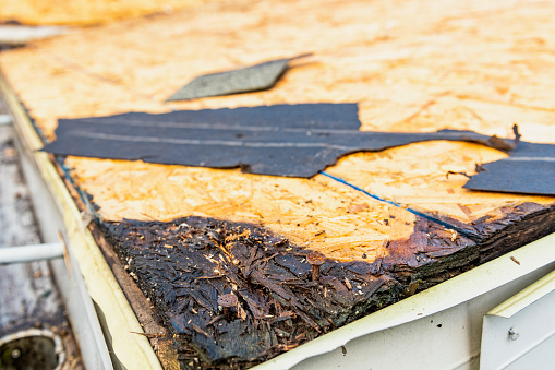 Rot to the OSB sheathing was discovered once the old shingles and tar paper were removed during a home renovation that included a re-roofing of the entire residential roof.