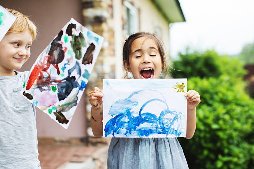 Children showing their drawings