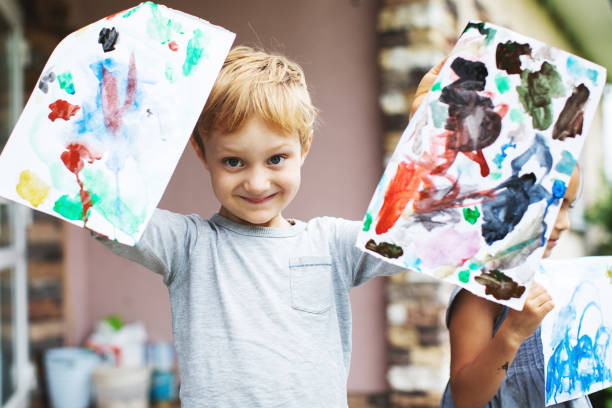istock Children showing their drawings 1130525925
