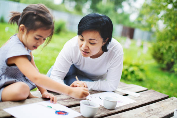 istock Mother painting with her child 1130525944