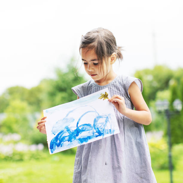 istock Little girl showing his drawing 1130525961