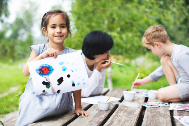 Mother painting with her children