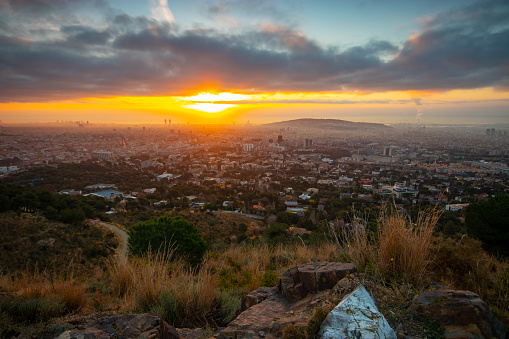 Barcelona's sunrise during winter, February - Wide angle shot with warm colors in the land and grass