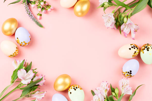 istock Festive Happy Easter background with decorated eggs, flowers, candy and ribbons in pastel colors on pink. Copy space 1130526173