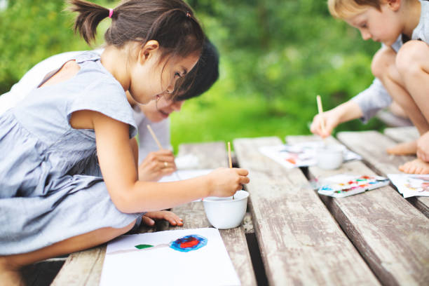 istock Mother painting with her children 1130528511