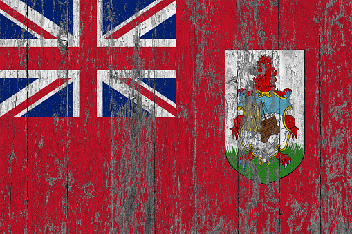 Flag of Bermuda painted on worn out wooden texture background.