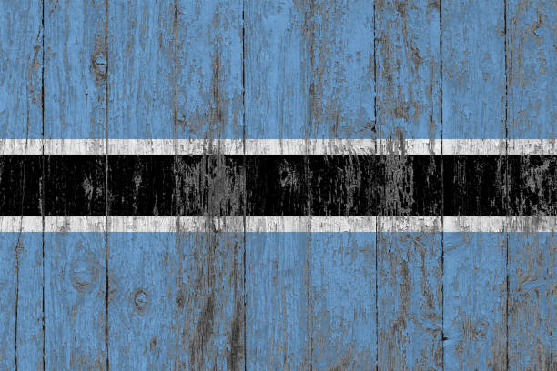 Flag of Botswana painted on worn out wooden texture background.