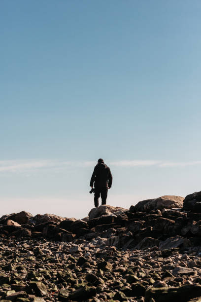 istock Adventure man Walking on the Rocks 1130529911