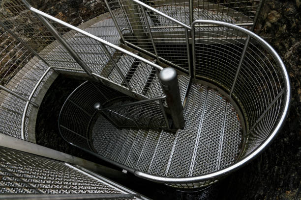 istock winding steel stairs inside of building 1130530882