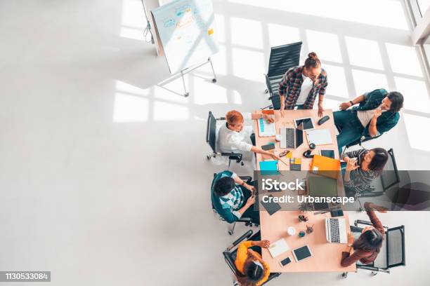 Multiethnic Diverse Group Of Business Coworkers In Team Meeting Discussion Top View Modern Office With Copy Space Partnership Professional Teamwork Startup Company Or Project Brainstorm Concept Stock Photo - Download Image Now