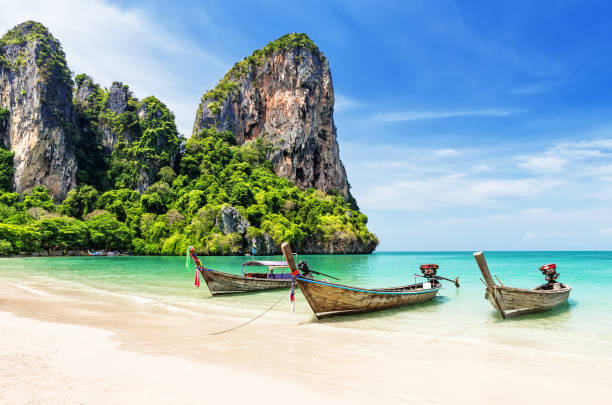 Thai traditional wooden longtail boat Thai traditional wooden longtail boat and beautiful sand Railay Beach in Krabi province. Ao Nang, Thailand. koh poda stock pictures, royalty-free photos & images