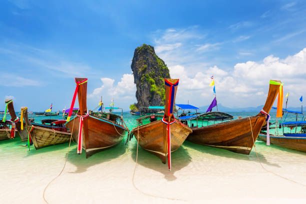 Thai traditional wooden longtail boat Thai traditional wooden longtail boat and beautiful sand beach at Koh Poda island in Krabi province. Ao Nang, Thailand. koh poda stock pictures, royalty-free photos & images