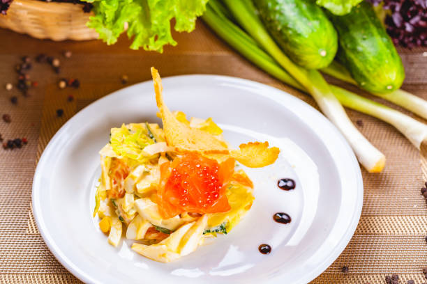 istock Salad with salmon and avocado on white plate 1130533955