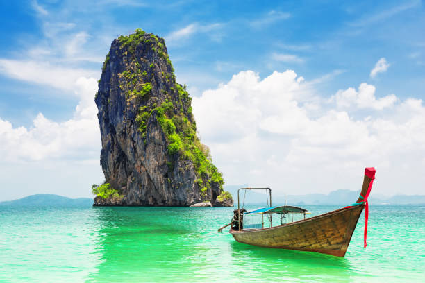 Thai traditional longtail boat and beautiful sand beach Thai traditional wooden longtail boat and beautiful sand beach at Koh Poda island in Krabi province. Ao Nang, Thailand. koh poda stock pictures, royalty-free photos & images