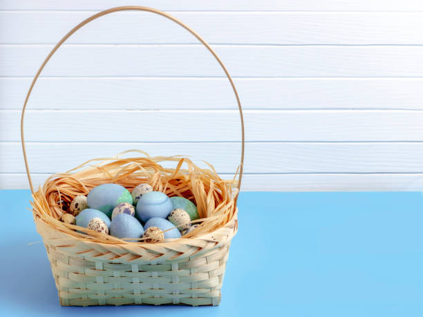 istock Easter eggs in the basket on a white wooden background. 1130535792