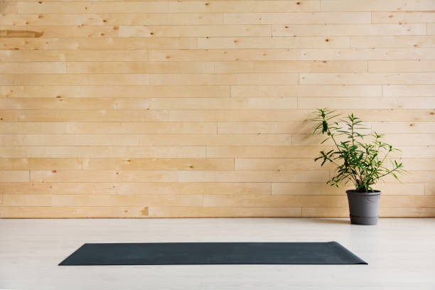 Gym with yoga mat interior Yoga mat on a wooden background. Equipment for yoga. Concept healthy lifestyle exercise room photos stock pictures, royalty-free photos & images