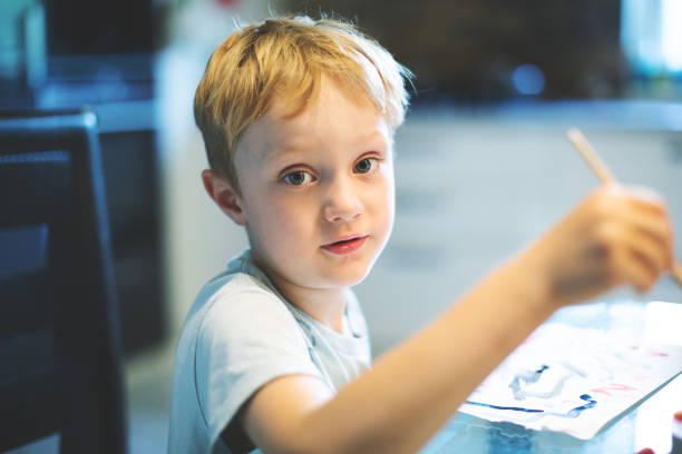 istock Little boy painting 1130538377